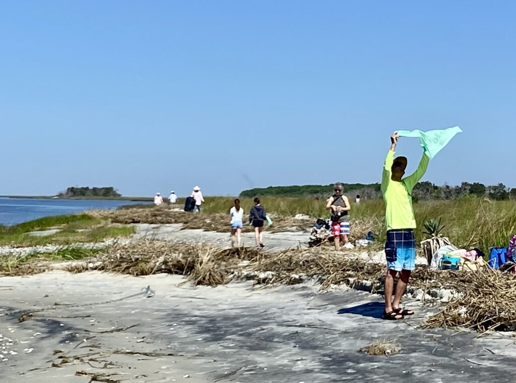 14. Host a Beach or Marina Cleanup<br>One week after the regatta we worked with Clean Coast to cleanup trash on Raccoon Key, using biodegradable, recycled trash bags.