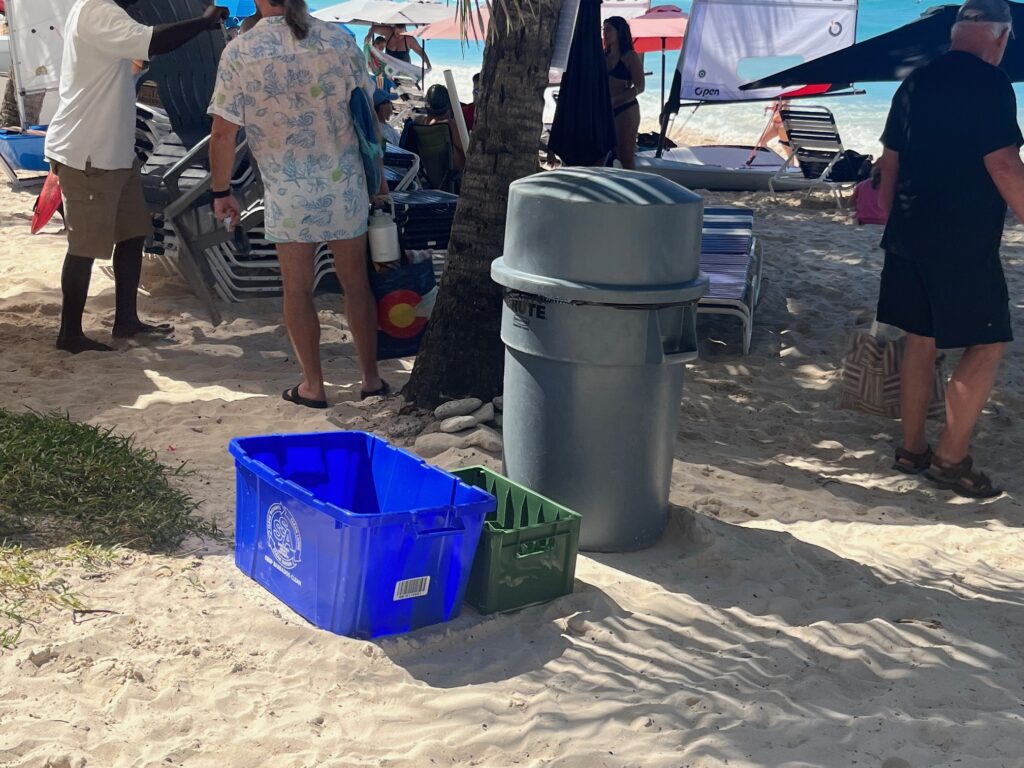 11. Ensure Proper Waste Bin Placement and Signage<br>All of our bottles are recycled. Green containers for beer bottles as well as larger recycling blue bins were placed centrally underneath hand painted reusable signs. The regular garbage bin was placed next to recycling station.
