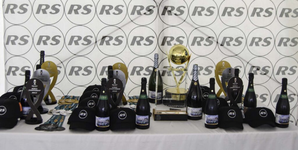 5. Award Practical Items or Use a Perpetual or Upcycled Trophy<br>The trophies for the overall winners of the RS21 World Championship are passed on to new winners each edition. In addition to the trophies, practical and reusable items such as caps and class-branded waterproof bags were awarded to the winning crews.
