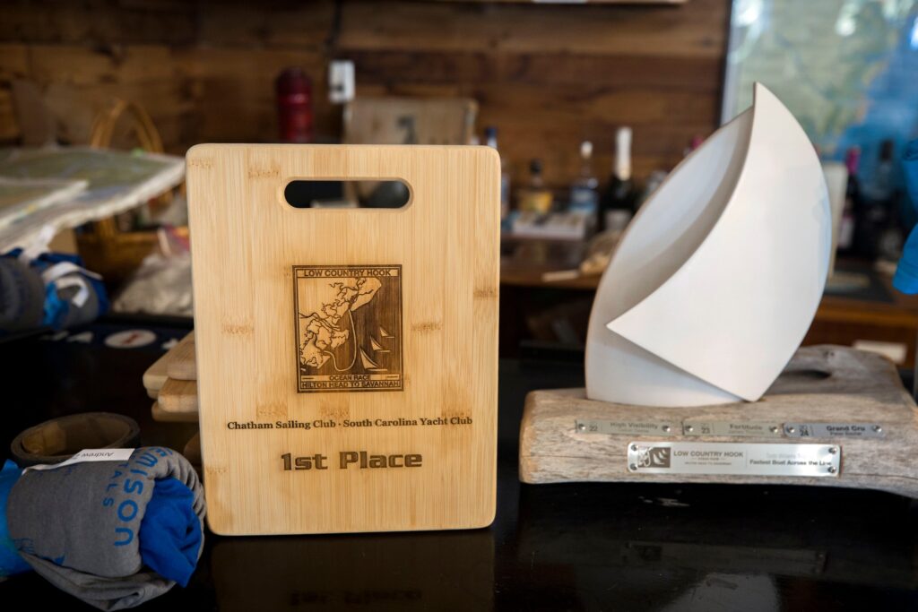 5. Award Practical Items or Use a Perpetual or Upcycled Trophy<br>We try to one-up ourselves with functional and sustainable awards each regatta. This year we gave bamboo cutting boards for individual awards and also had our annual award for the best sportsmanship in the regatta.