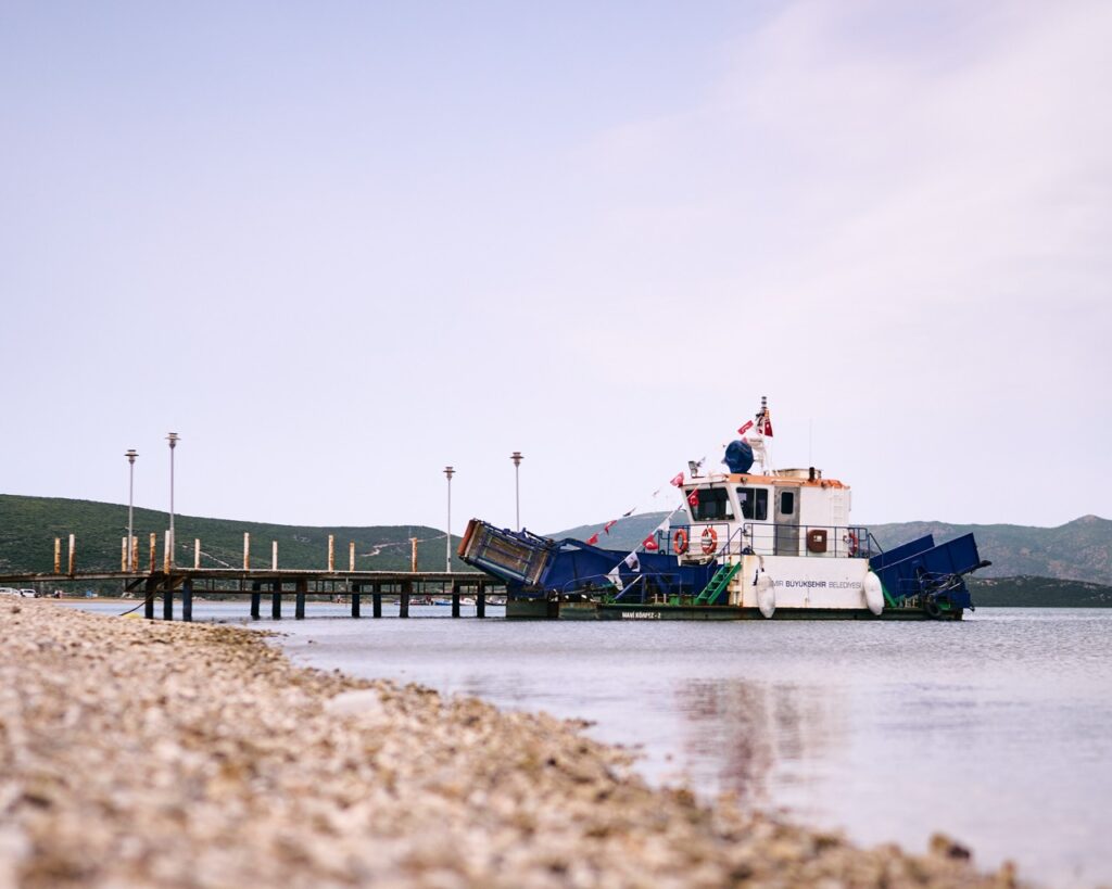 7. Involve Local Organizations<br>After the publicity on water pollution last year, we managed to get from the Izmir municipality this barge, which was stationed in the bay of Urla for two weeks and fishing trash out of the water.