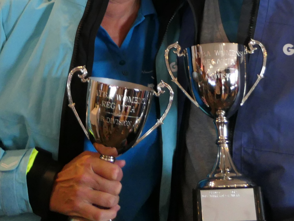 5. Award Practical Items or Use a Perpetual or Upcycled Trophy<br>5. At Prizegiving, WOWW gives out one perpetual trophy for each of the three divisions. Each winning skipper got a wet weather jacket and all of the crew got a beach towel. The second and third placed skippers each got a gear bag (left of Photo 5b)) with some goodies inside. All prizes are usable, wearable or consumable (food or drink) so nothing plastic or gimmicky.
