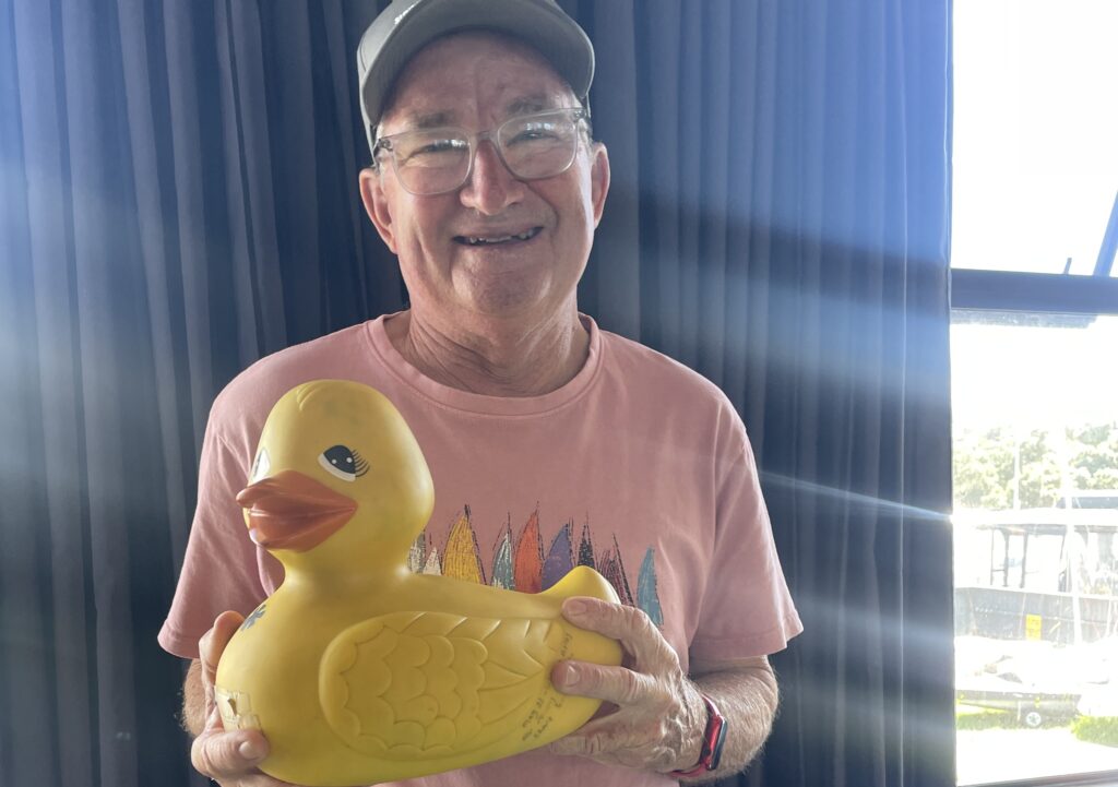 5. Award Practical Items or Use a Perpetual or Upcycled Trophy<br>There are several ways we did this and aimed to keep it fun and meaningful. A duck is handed out every year to someone with a funny story from the regatta. There was also a special painting which was awarded to the winners of the invitation race. 
Medals from the previous sunburst nationals which were held at Wakatere (in 2017) which had been sitting in cupboards were handed to the young competitors, along with leftover T-shirts. This meant no new t-shirts were being made, and instead we were recycling existing stock. 
Plenty of hats for all competitors too - vital for sailors! 