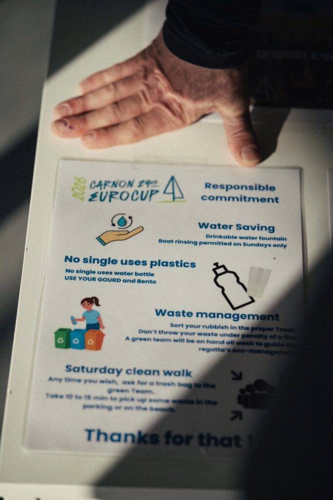 8. Post Educational and Reusable Signage<br>8 - During the event, we used reusable and educational signage to inform sailors, coaches, volunteers and visitors about our sustainability actions, including waste sorting, water refill points, beach clean-up initiatives and environmental awareness activities. 
We deliberately limited the use of laminated signs, using them mainly to remind sailors not to rinse their boats and to display key instructions at registration.
All reusable signs were kept for the next edition of the event.
Each bi-flux waste sorting point also had its own dedicated signage and flag to make it clearly visible on site.
