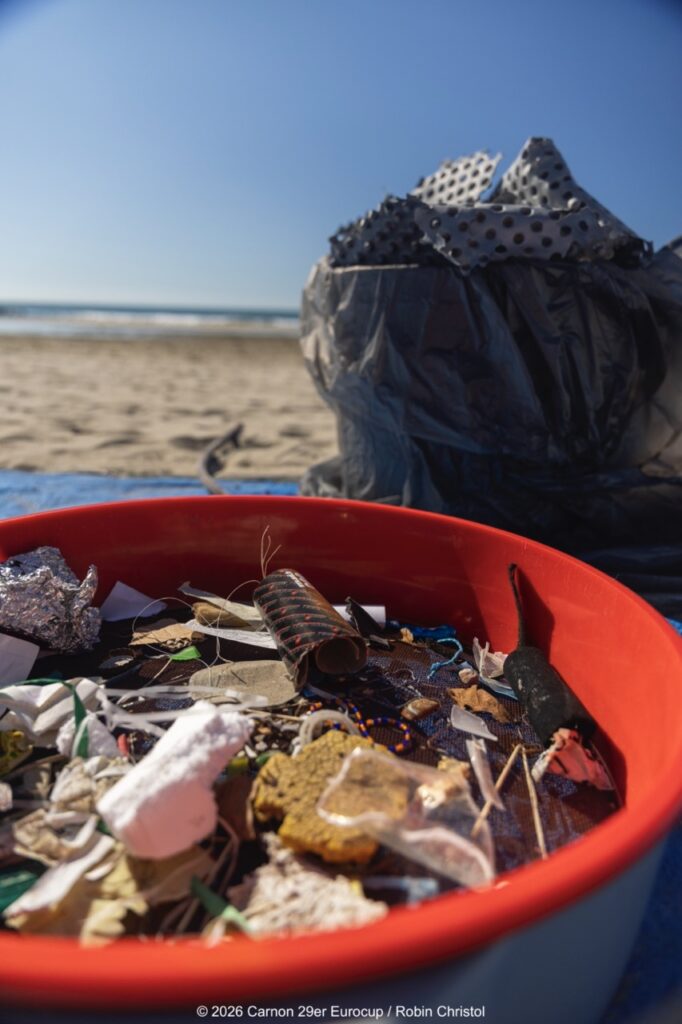 14. Host a Beach or Marina Cleanup<br>14 - We organized a beach clean-up with Ocean Protection France, involving volunteers and members of the public outside the regatta.
We also organized a dedicated clean-up action with the young sailors during a no-wind break. This was a great success and created a strong collective moment.
Initially, we had planned to let sailors join the Green Brigade at any time during the weekend, take part in a beach clean-up, and enter a photo contest. However, this format proved difficult to combine with the rhythm and timing of the races.
We are now looking for new and innovative ideas for next year to further involve young sailors in environmental action during the event.
