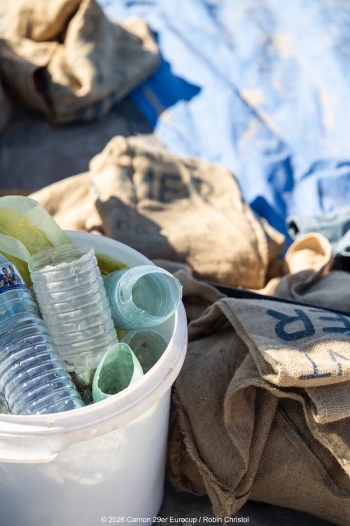 14. Host a Beach or Marina Cleanup<br>14 - We organized a beach clean-up with Ocean Protection France, involving volunteers and members of the public outside the regatta.
We also organized a dedicated clean-up action with the young sailors during a no-wind break. This was a great success and created a strong collective moment.
Initially, we had planned to let sailors join the Green Brigade at any time during the weekend, take part in a beach clean-up, and enter a photo contest. However, this format proved difficult to combine with the rhythm and timing of the races.
We are now looking for new and innovative ideas for next year to further involve young sailors in environmental action during the event.
