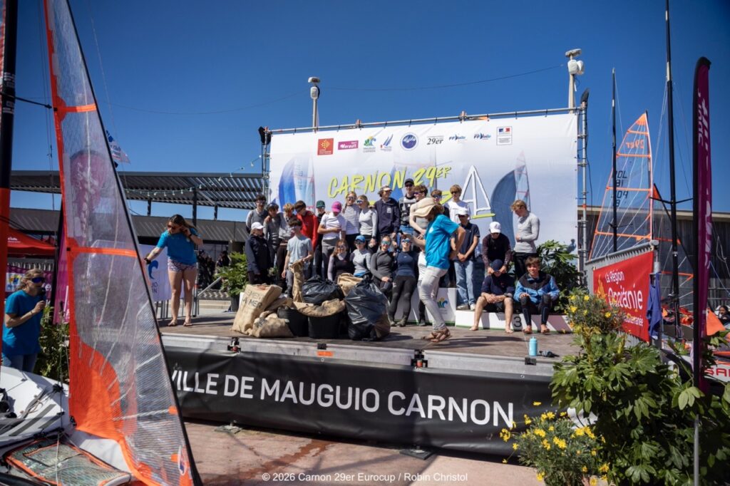 14. Host a Beach or Marina Cleanup<br>14 - We organized a beach clean-up with Ocean Protection France, involving volunteers and members of the public outside the regatta.
We also organized a dedicated clean-up action with the young sailors during a no-wind break. This was a great success and created a strong collective moment.
Initially, we had planned to let sailors join the Green Brigade at any time during the weekend, take part in a beach clean-up, and enter a photo contest. However, this format proved difficult to combine with the rhythm and timing of the races.
We are now looking for new and innovative ideas for next year to further involve young sailors in environmental action during the event.
