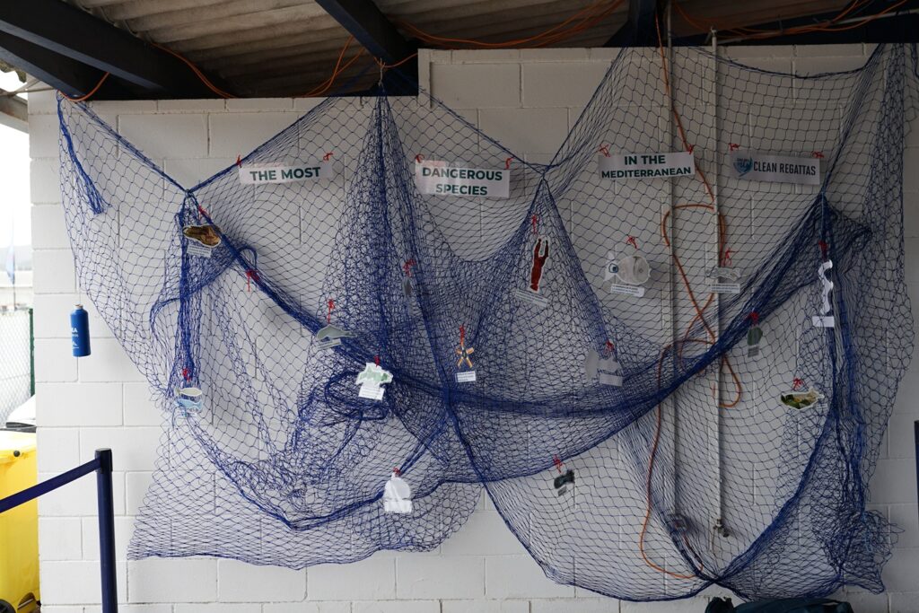 6. Publicize Your Sustainability Efforts<br>Sustainability initiatives were promoted through event communications, signage, and announcements on website and social networks and encourage environmentally responsible behavior.

A noveltey in this edition: The sustainable photocall, created using recycled old fishing nets from local fishermen, had great success and helped raise awareness about marine waste reduction and creative material reuse.
