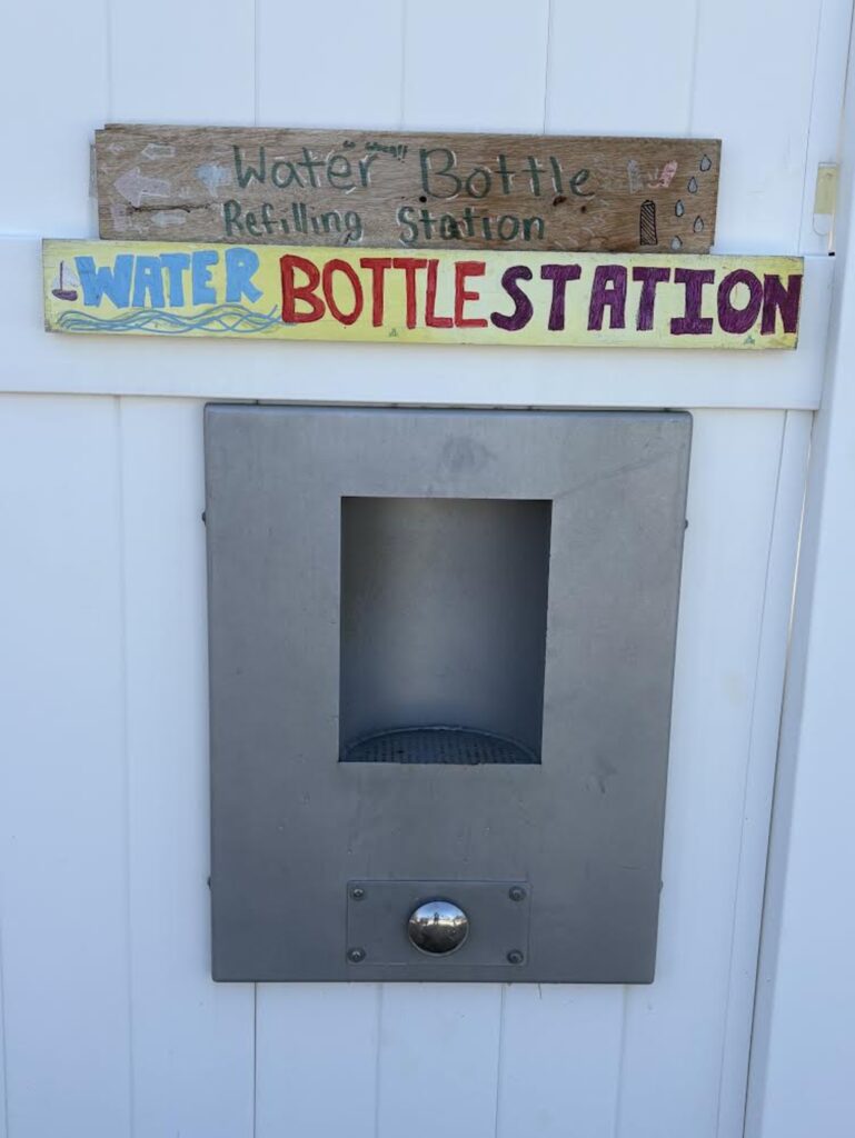 1. Eliminate Single-Use Water Bottles and Provide Water Refill Stations<br>Sailors used personal water bottles throughout the day; breakfast, on the water and at the reception. Water from water station and large thermos and lemonade from large jugs were available for drinks.   Cups from repurposed materials were provided to 3 crew members of the committee boat