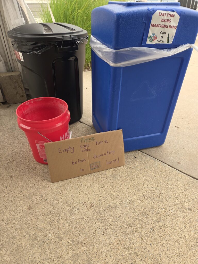 11. Ensure Proper Waste Bin Placement and Signage<br>A can and bottle collection station was set up that included a bucket to collect left over liquid placed next to a barrel marked with a sign for the "East Lyme Viking Marching Band."  This is another connection with a community group where we impart our efforts of sustainable seaside life! 