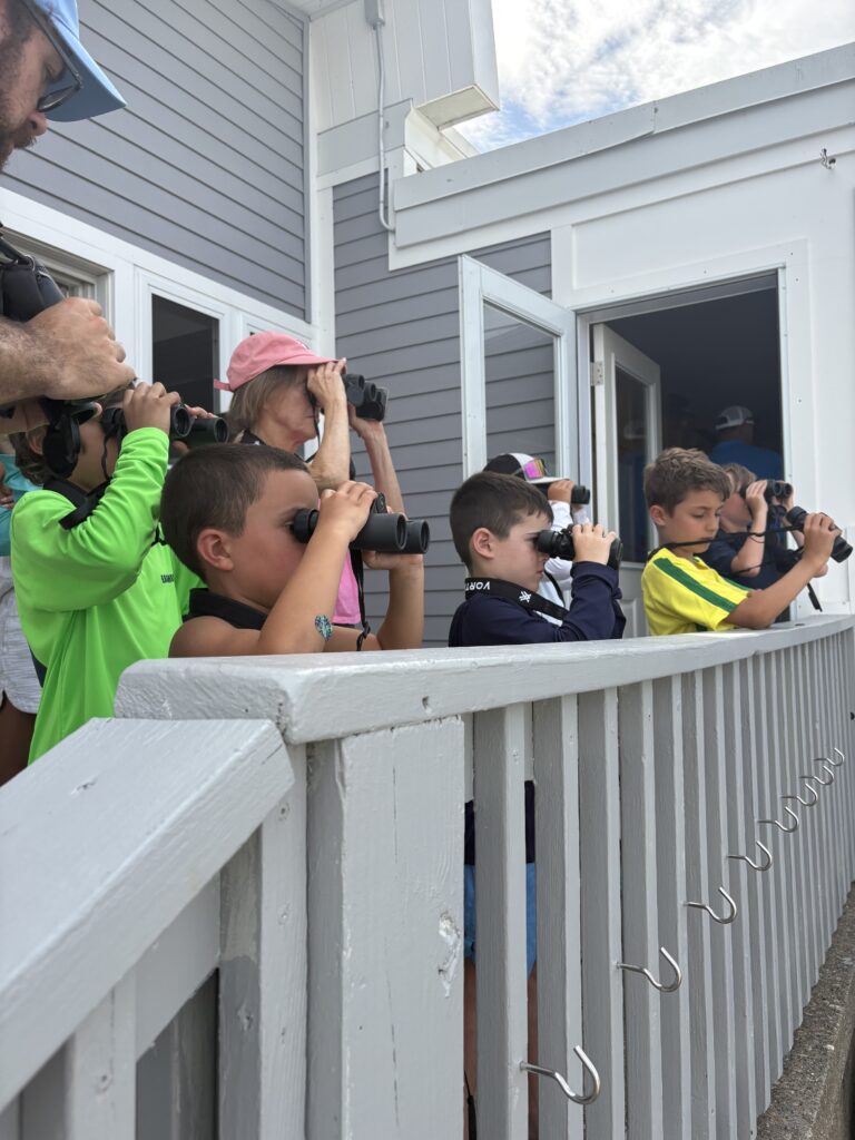 7. Involve Local Organizations<br>This year we reached out the CT Audubon society to learn about ways to protect our sea birds and their habitats. Joe Attwater, educator from the Audubon Society, provided a wonderful presentation which included observing sea birds through binoculars. Also, Olivia Murin, one of our youth green team members is working on her Girl Scout Gold Award on green sailing practices. She has helped throughout the sailors for the sea process. 