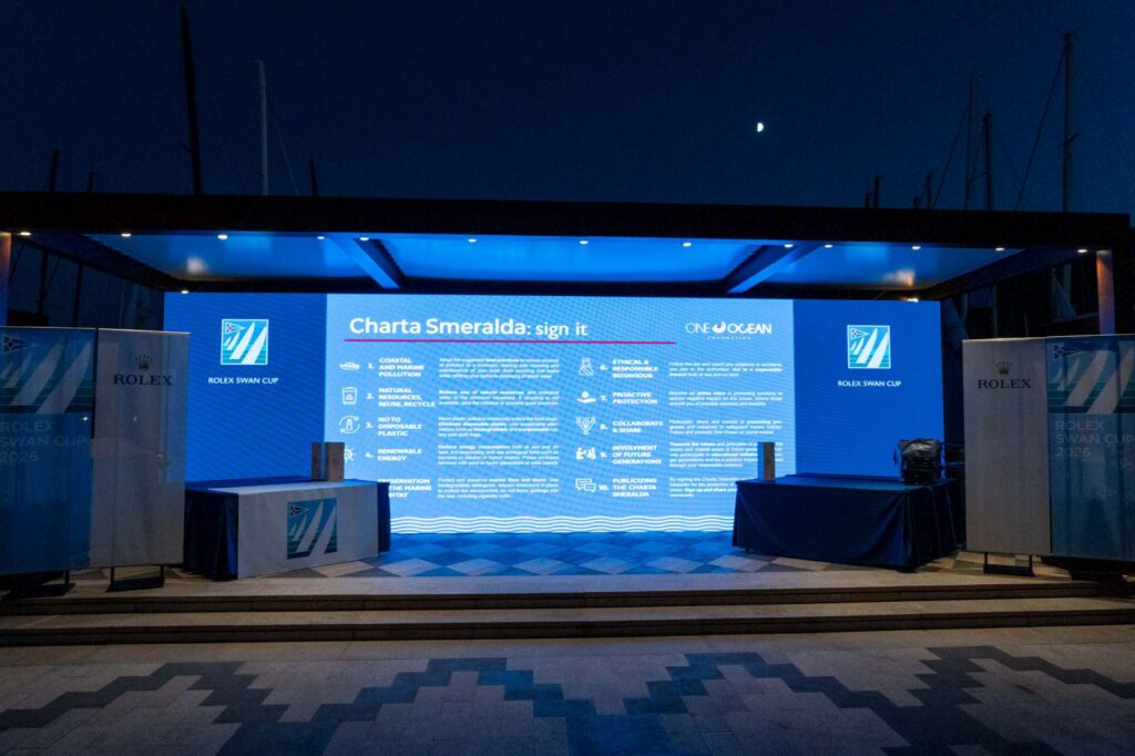 20. Inspire Future Action<br>Environmental awareness was integrated into several aspects of the event. Sustainability principles inspired by the Charta Smeralda were communicated through the official event documents and reinforced through visual content displayed on the LED wall in Piazza Azzurra, reaching both participants and visitors. The commitment to reducing environmental impact was also promoted at the drinking water fountain, where the message “Be the Wave of Change” encouraged simple everyday actions such as refilling reusable bottles and reducing reliance on single-use plastics.
