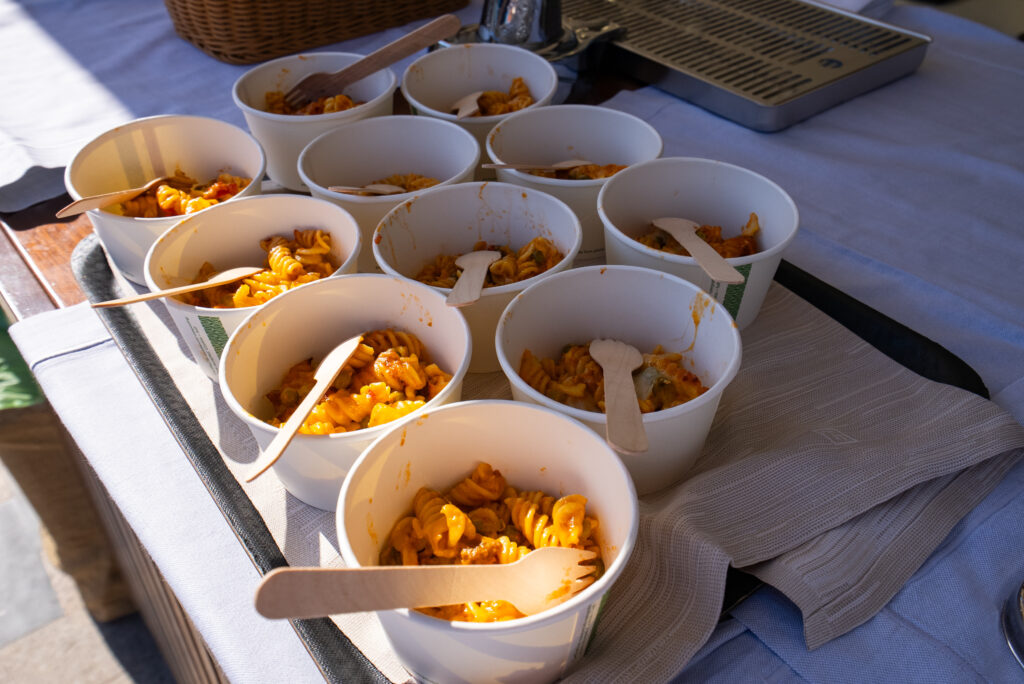 3. Serve Food with Plastic-Free Dinnerware<br>After-race refreshments were served using biodegradable alternatives, including cellulose pulp plates, paper cups and wooden cutlery. During social events held at the YCCS, food and beverages were served on reusable ceramic plates, in glassware and with metal cutlery, minimizing the use of single-use materials.