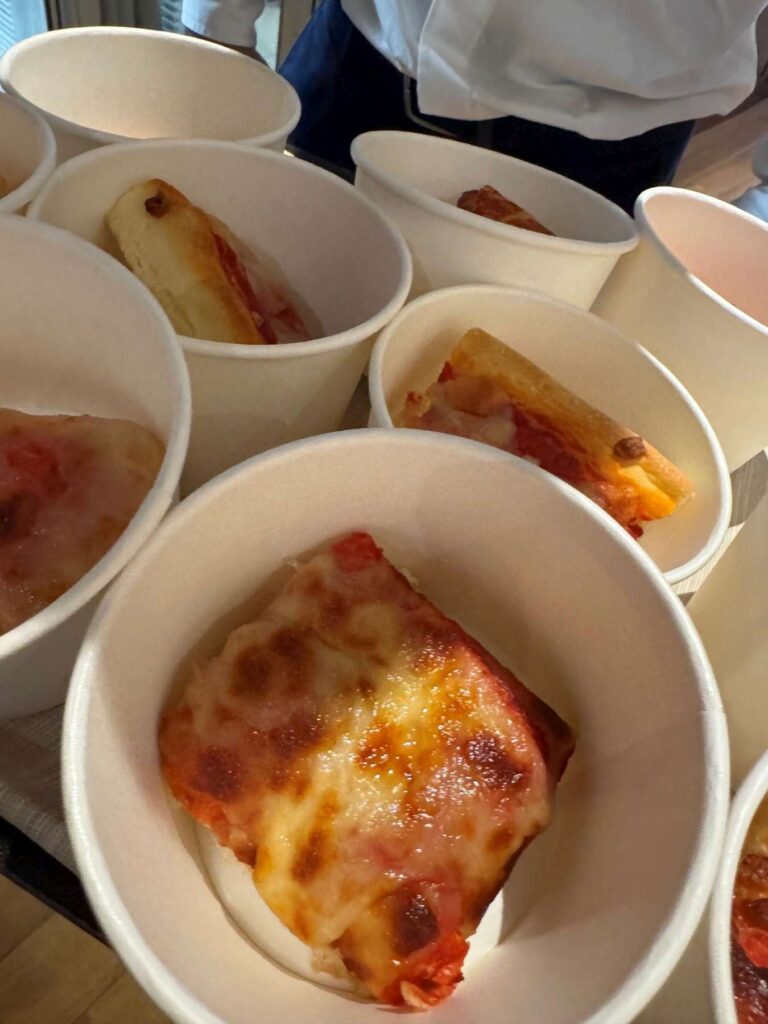 9. Serve Local Food or Source Seafood Sustainably<br>During the event, local food was served, including pasta, pizza and rice dishes prepared with locally sourced vegetables, as shown in the attached photos.
